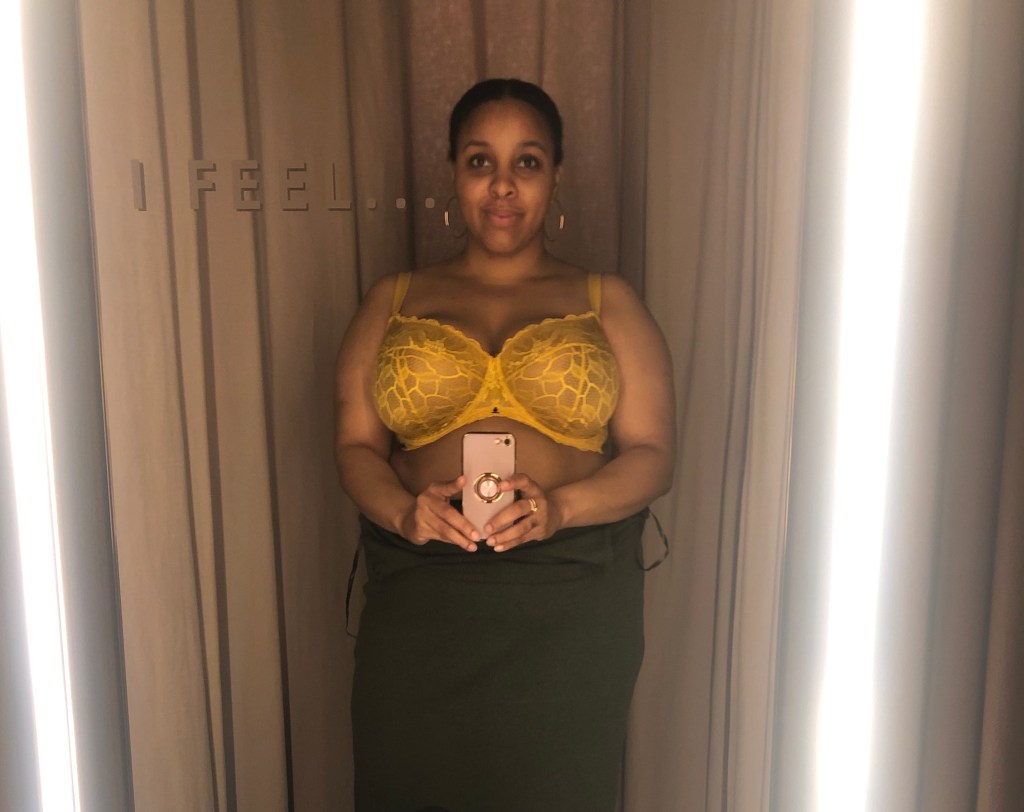 Changing room picture of Beija London mustard bra, and smiling blogger. 